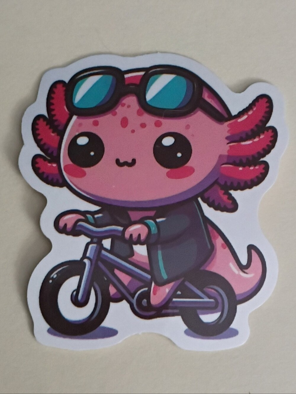 10/$10 Sticker - Pink Axolotl Riding Bike w/ Green Jacket & Sunglasses